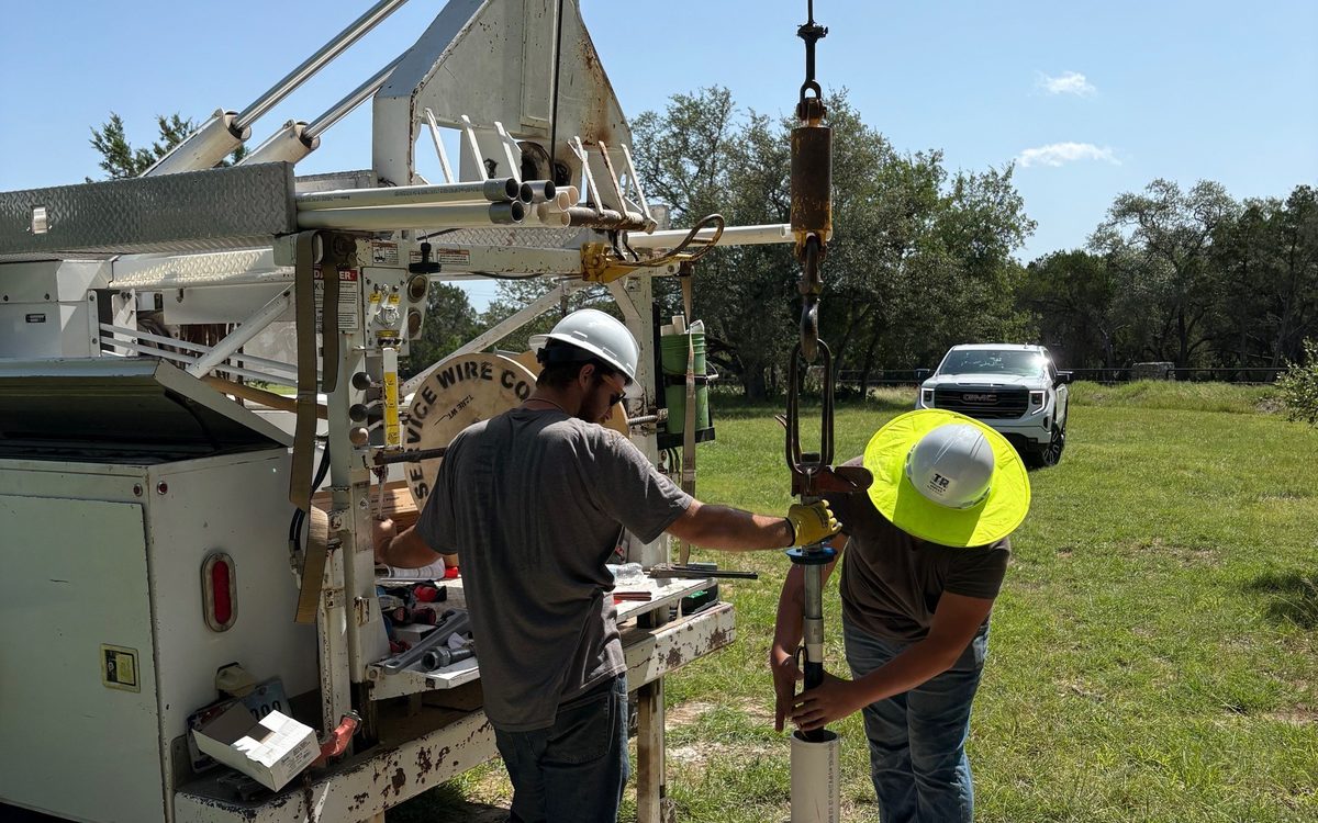 Crew servicing a wellhead and pump