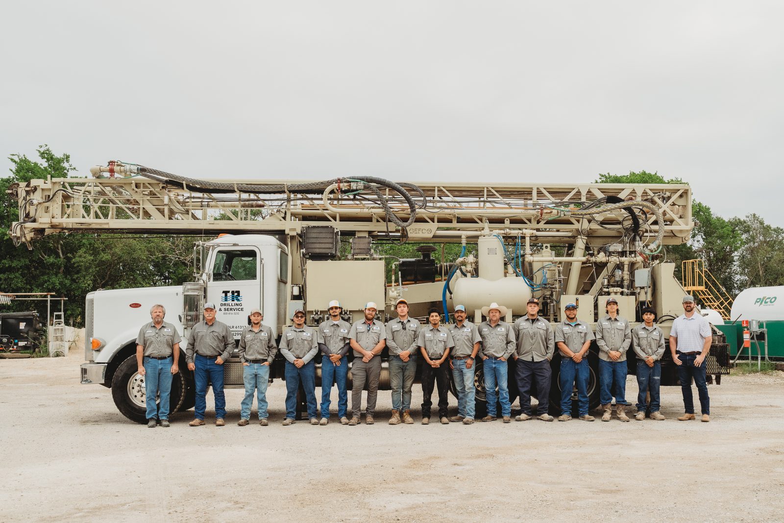 The TR Drilling & Service crew lined up in front of their drilling rig