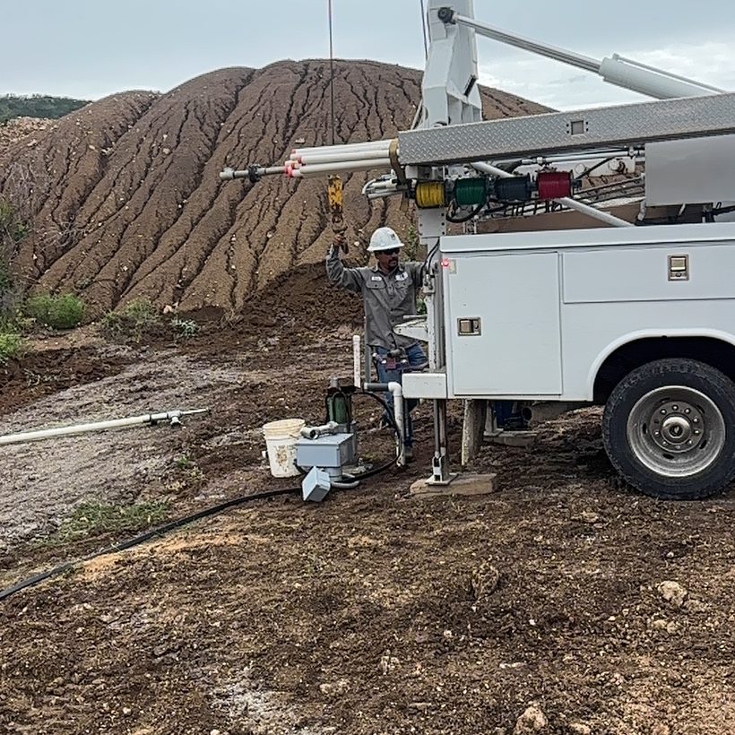 TR Drilling service rig hoisting a pump from a water well