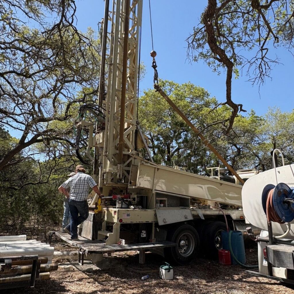 team drilling water well in the hill country