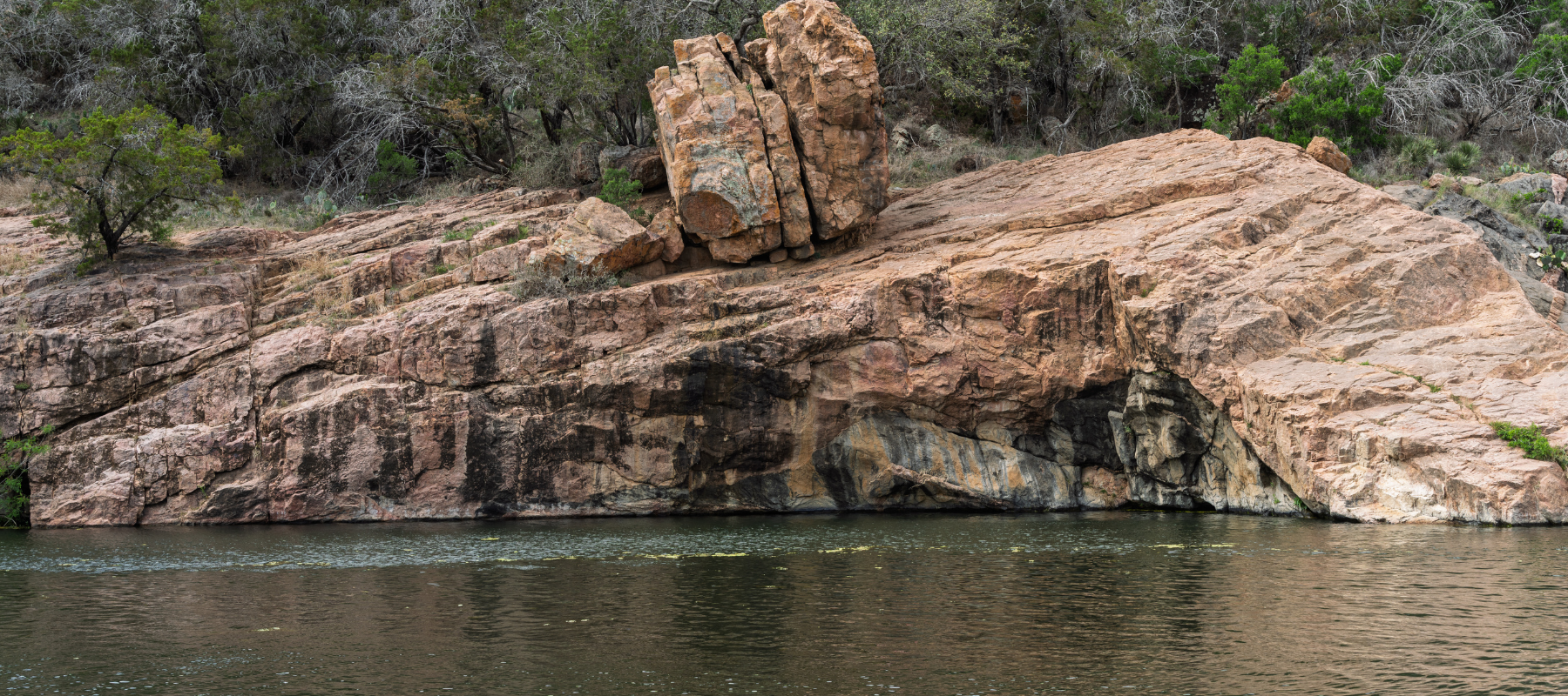 Rocky lakeside terrain in Burnet, Texas, representing the Central Texas landscape where TR Drilling provides water well drilling and pump services.